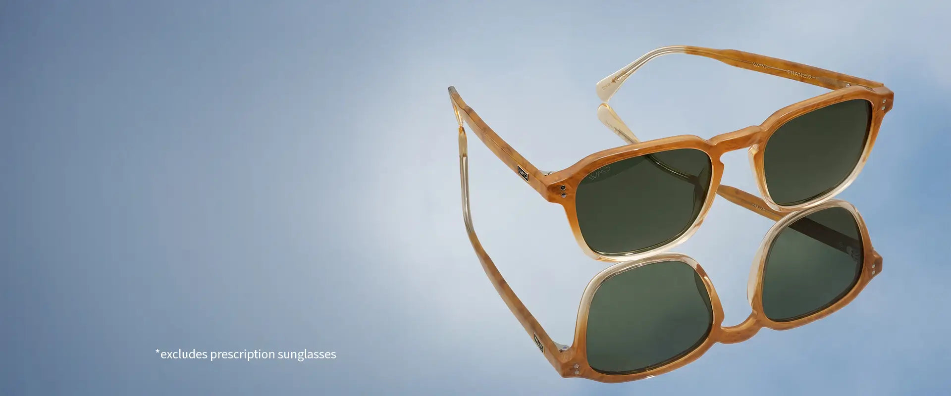 Sunset tortoise-colored rectangular sunglasses with green lenses on a reflective surface. Sale excludes prescription sunglasses.