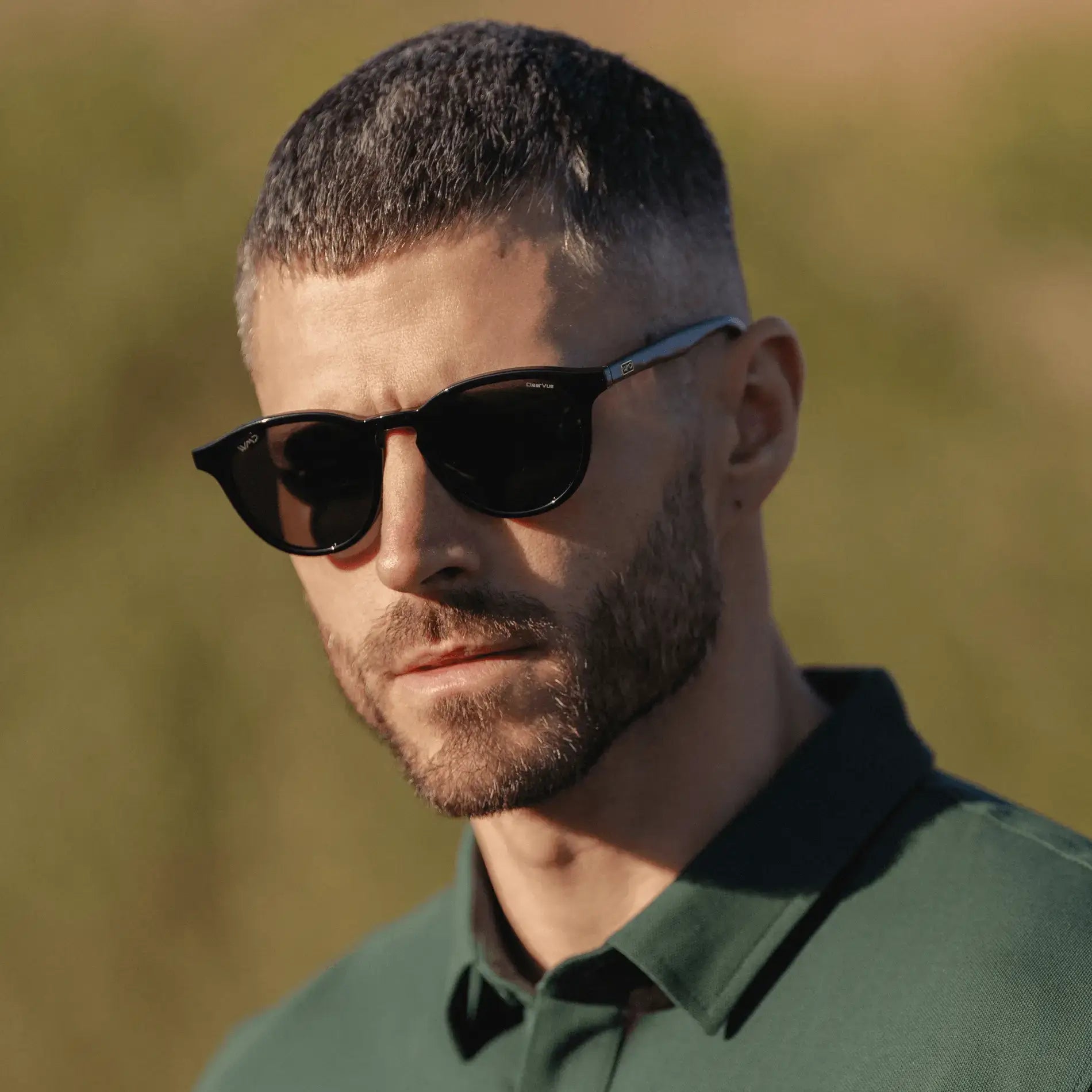 Black / Grey || Round prescription sunglasses with black frame, keyhole bridge, and grey lenses worn by a man outdoors