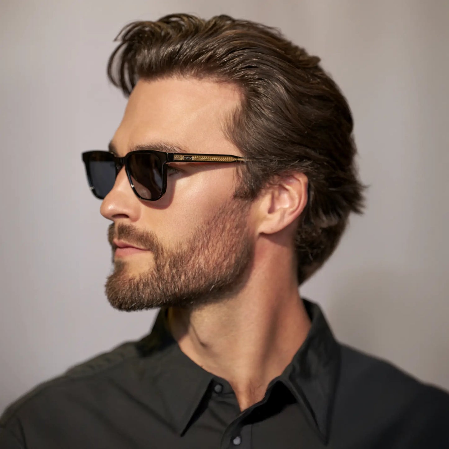 Black / Triple Black Lens || Side view of man wearing Rectangular Polarized Sunglasses with Black Frame and Black Lens against a grey background