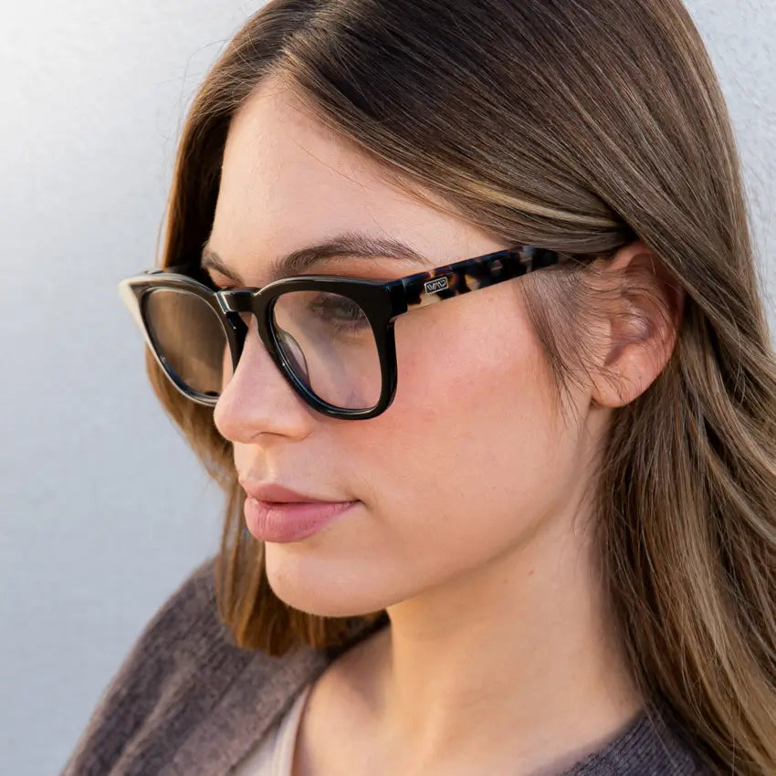 Black Beige Tortoise || Close up of Black oversized square frame glasses with clear lenses worn by woman in natural lighting 