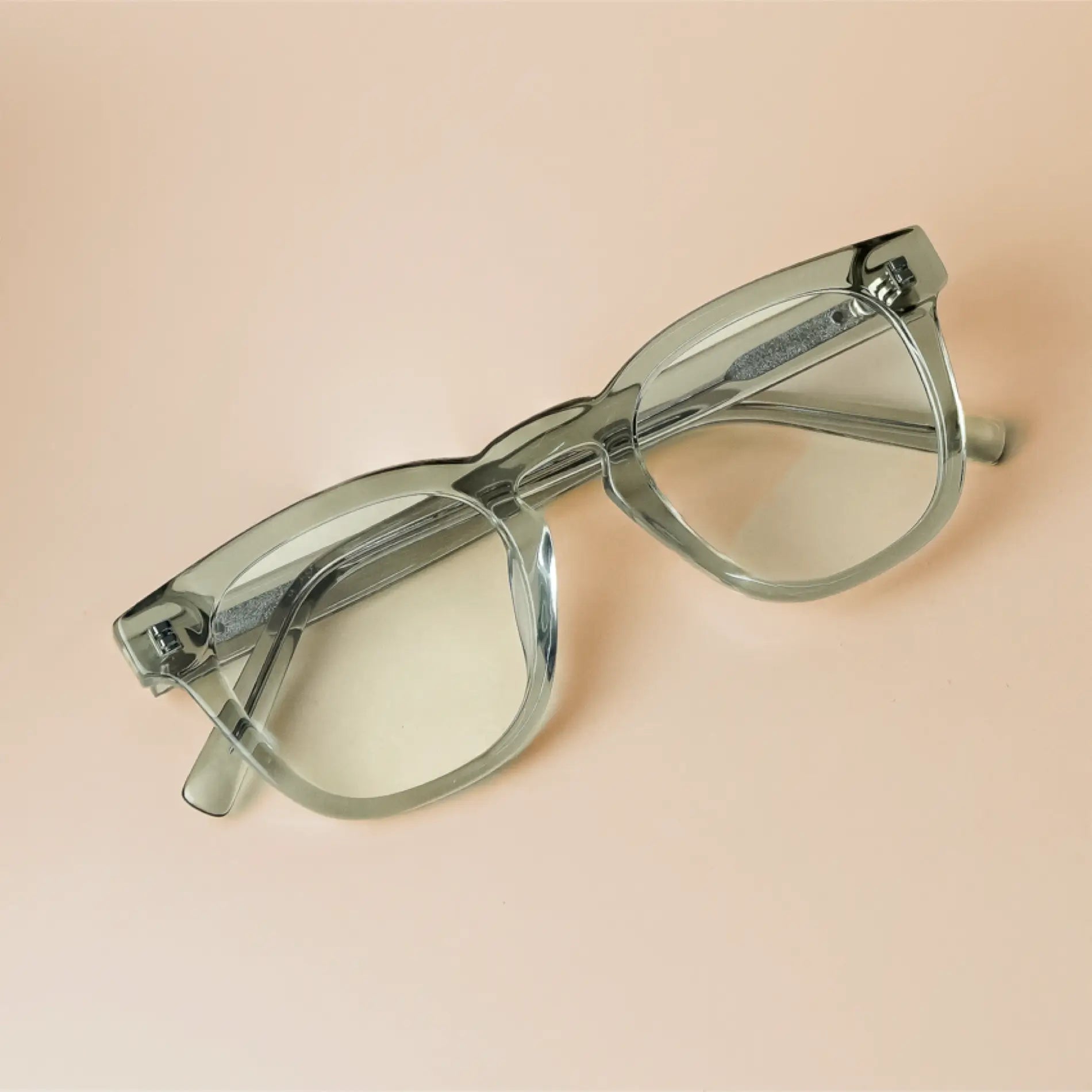 Sea Salt Grey || Grey acetate square prescription eyeglasses with keyhole bridge and clear lenses on beige surface