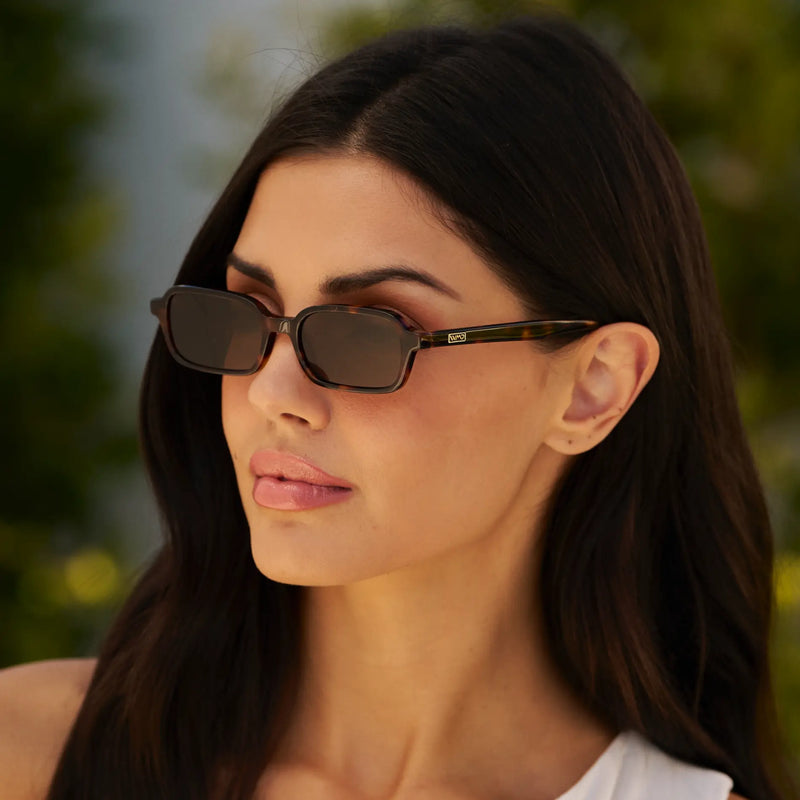 Woman wearing WMP Eyewear Ayla sunglasses in tortoise brown with dark brown lenses