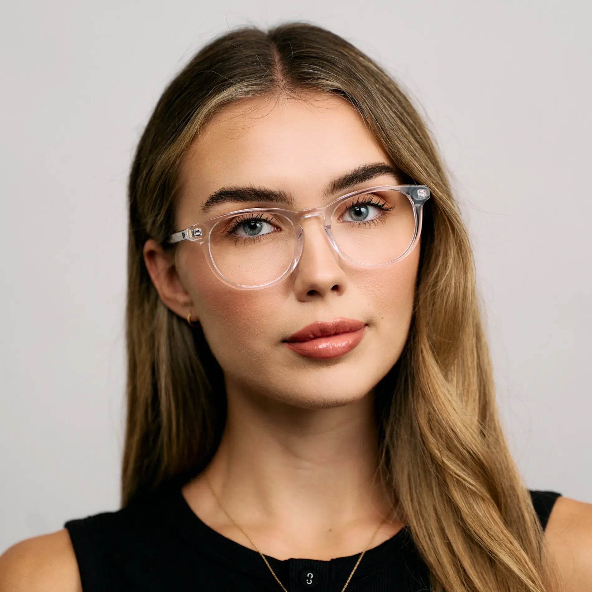 Clear || Female Model wearing Women's Retro-Inspired Oval Blue Light Blocking Glasses with a Clear Acetate Frame and Clear Lens