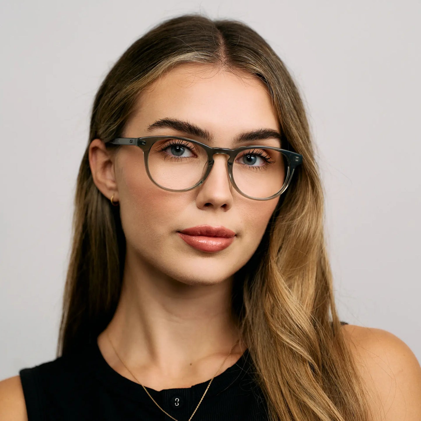 Pale Green || Female Model wearing Women's Retro-Inspired Oval Blue Light Blocking Glasses with a Pale Green Acetate Frame and Clear Lens