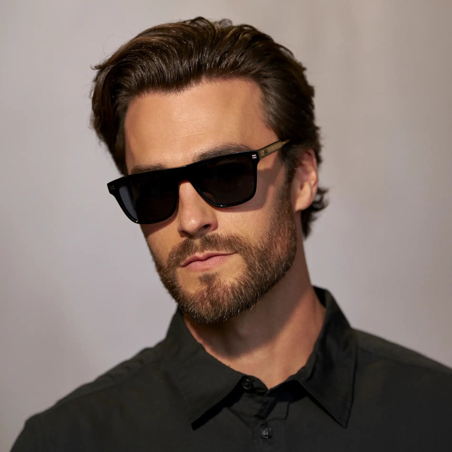 Black / Triple Black Lens || Front view of man wearing Rectangular Polarized Sunglasses with Black Frame and Black Lens against a grey background