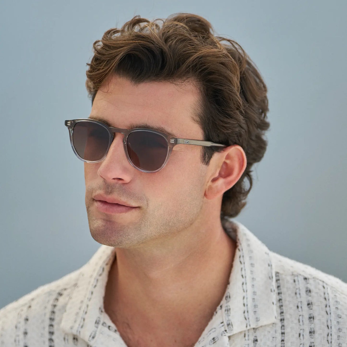 Charcoal Grey / Brown Gold Gradient Lens || Model wearing Men's Round Polarized Sunglasses with Charcoal Grey Frame and Brown Gold Gradient Lenses on a white background