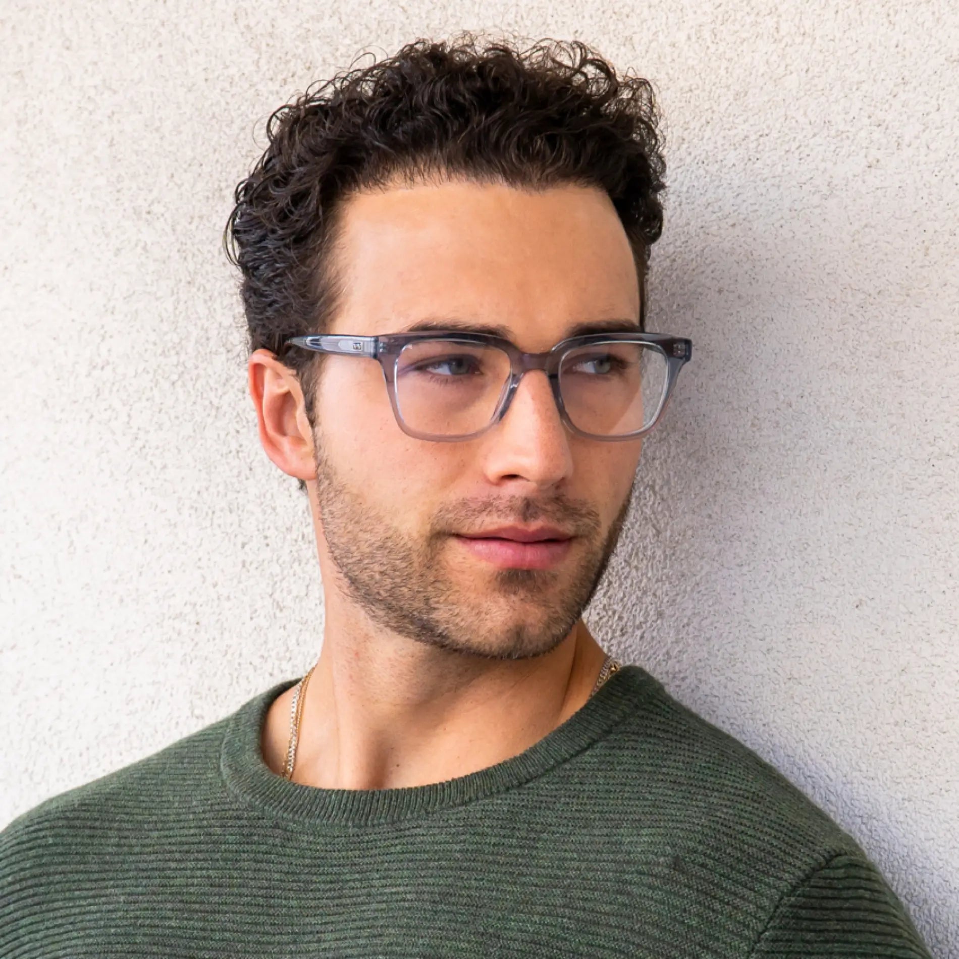 Denim Blue || Carson translucent blue square frame blue light glasses worn by man in green sweater against light wall