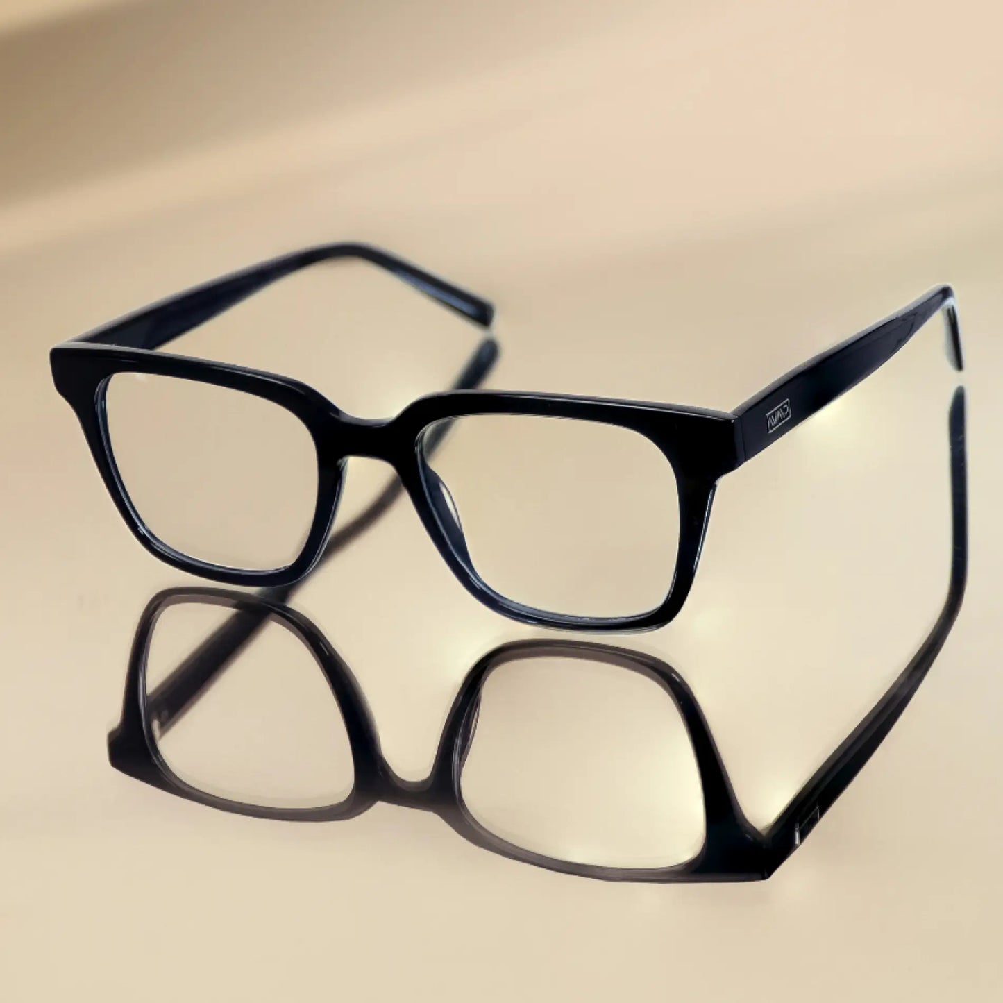 Glossy Black || Black square frame blue light glasses reflected on smooth beige surface