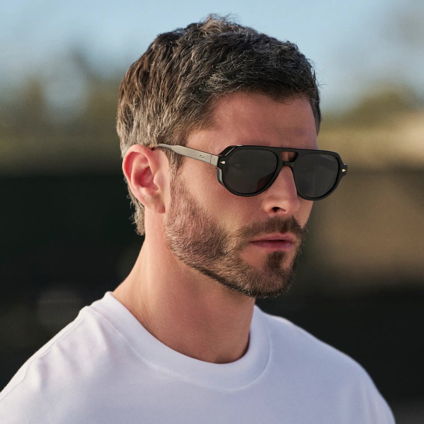 Black / Black Lens || Man wearing Geometric Aviator Sunglasses with Black Frame and Black Lens outdoors