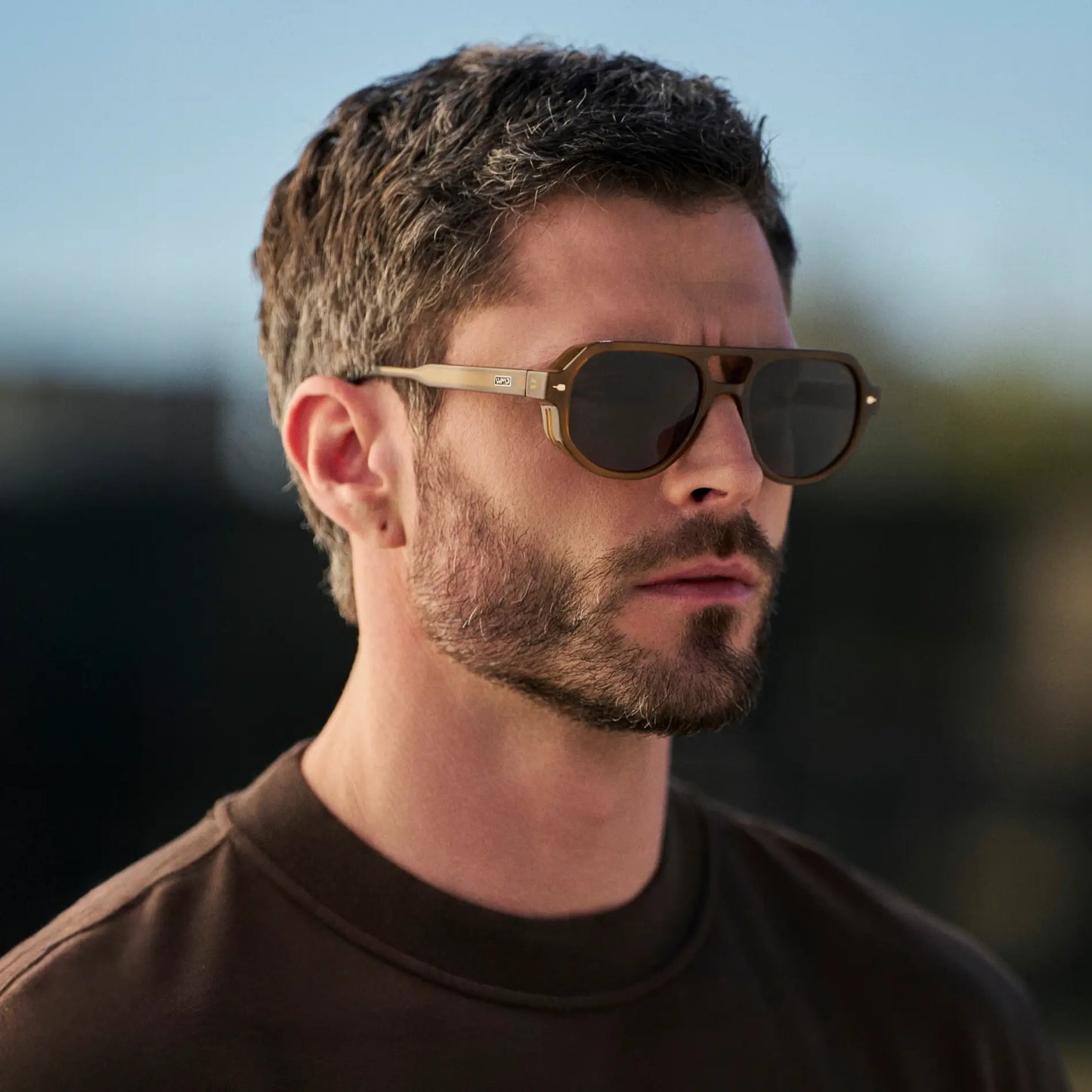 Dune Brown / Black Lens || Man wearing Geometric Aviator Sunglasses with Dune Brown Frame and Black Lens outdoors
