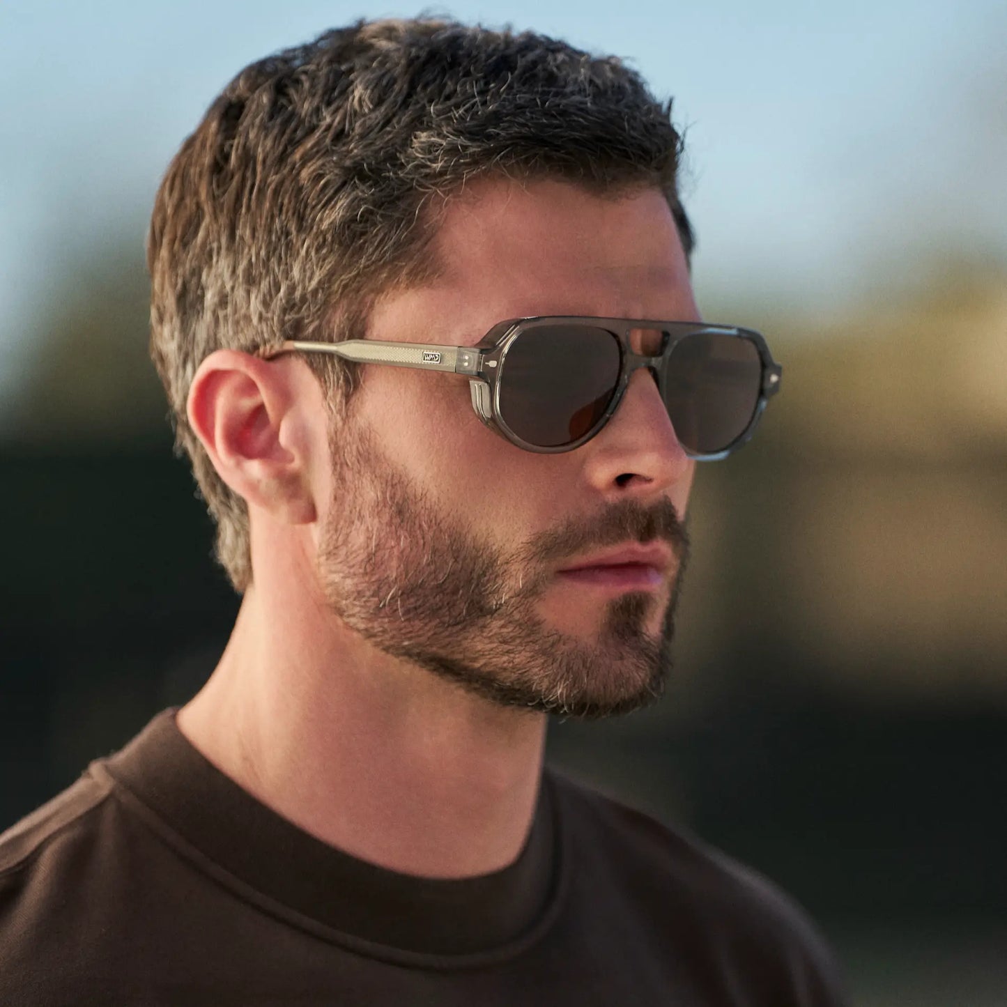 Sage Green / Brown Lens || Man wearing Geometric Aviator Sunglasses with Sage Green Frame and Brown Lens outdoors