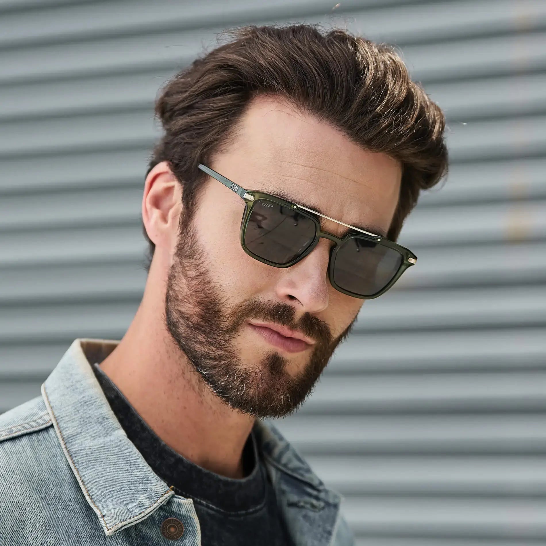 Emerald Green / Grey || Square modern prescription sunglasses with green metal and acetate frame, double bridge, and grey lenses worn by man outdoors