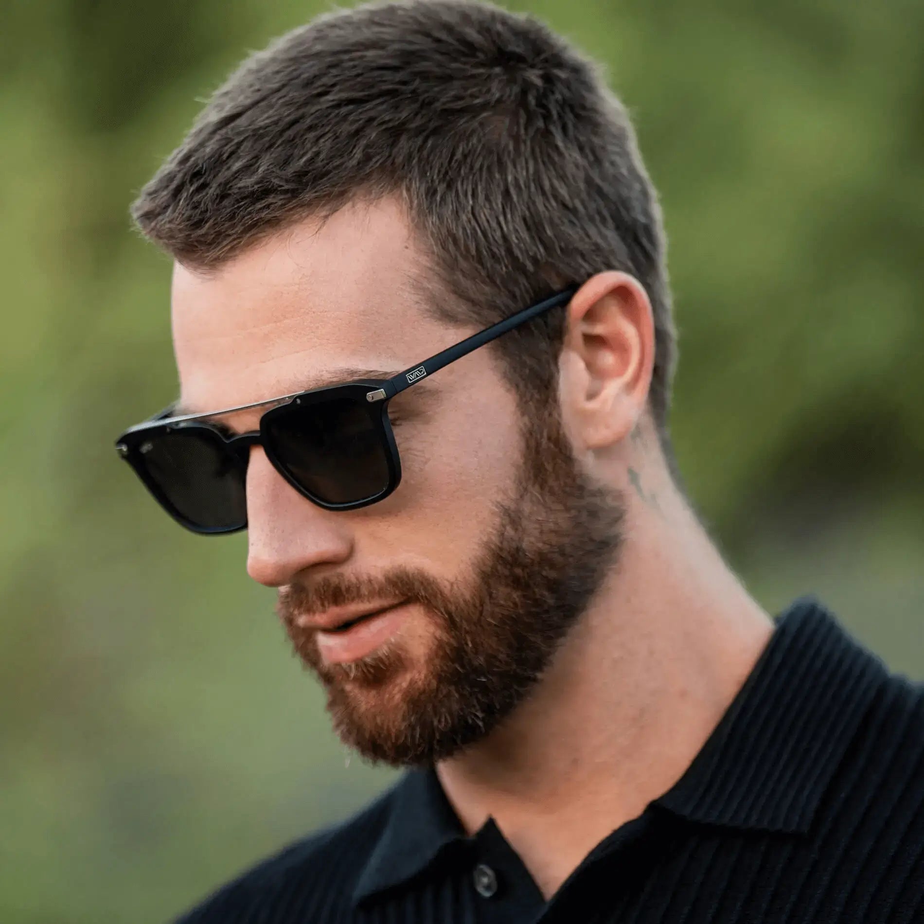 Matte Black / Grey || Square modern prescription sunglasses with slim black metal frame and double bridge worn by man outdoors