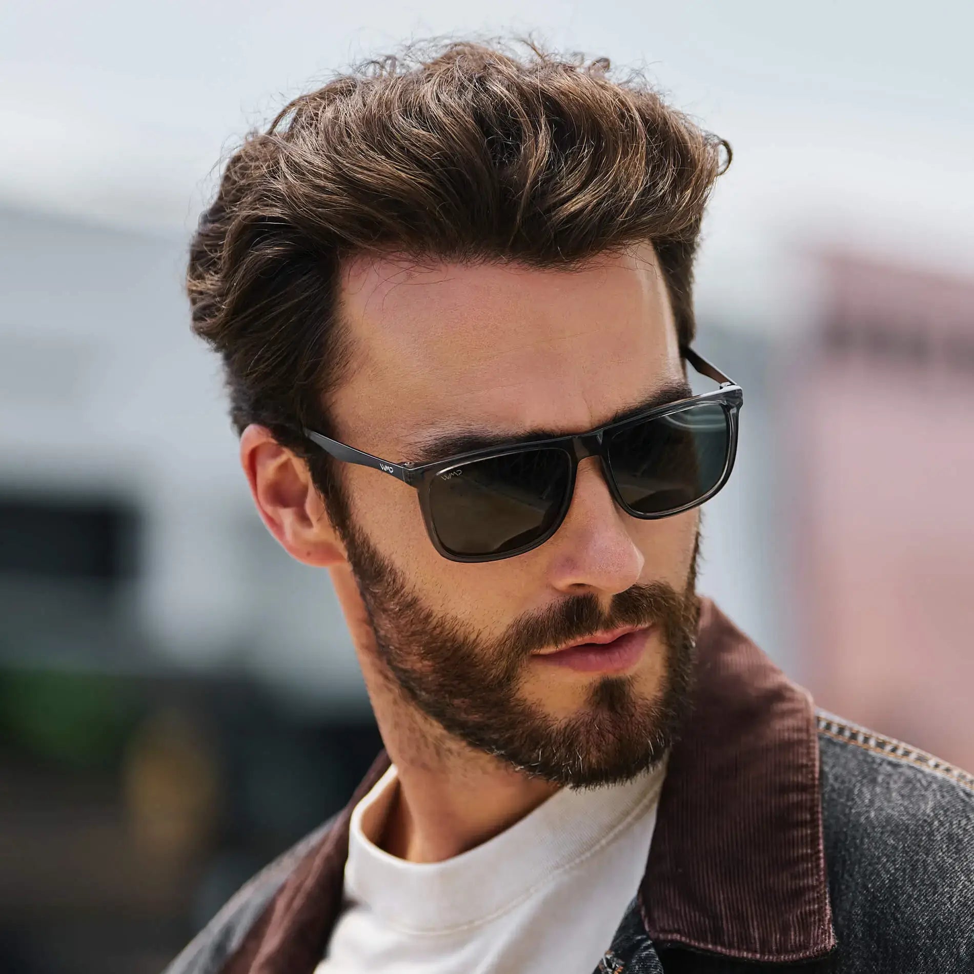 Steel Grey / G15 || Square modern prescription sunglasses with a steel grey acetate frame and green lenses worn by man outdoors