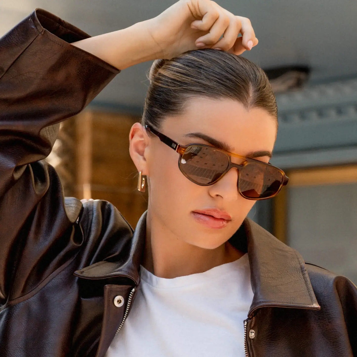 Golden Brown Grain / Amber || Aviator prescription sunglasses with thin acetate frame, keyhole bridge, and brown lenses worn by a woman outdoors