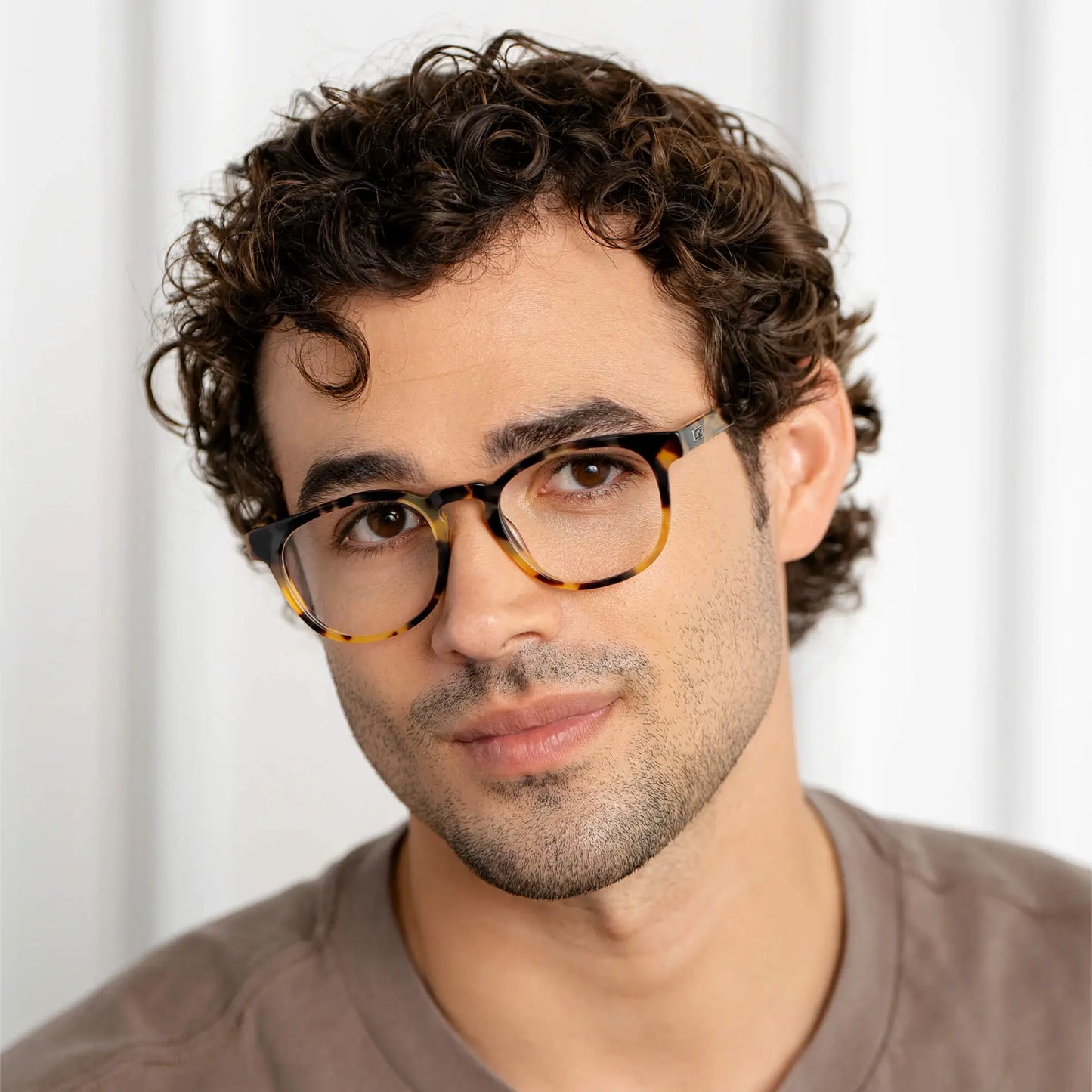 Dune Tortoise || Man wearing Cal blue light glasses with classic tortoise square frames against neutral background