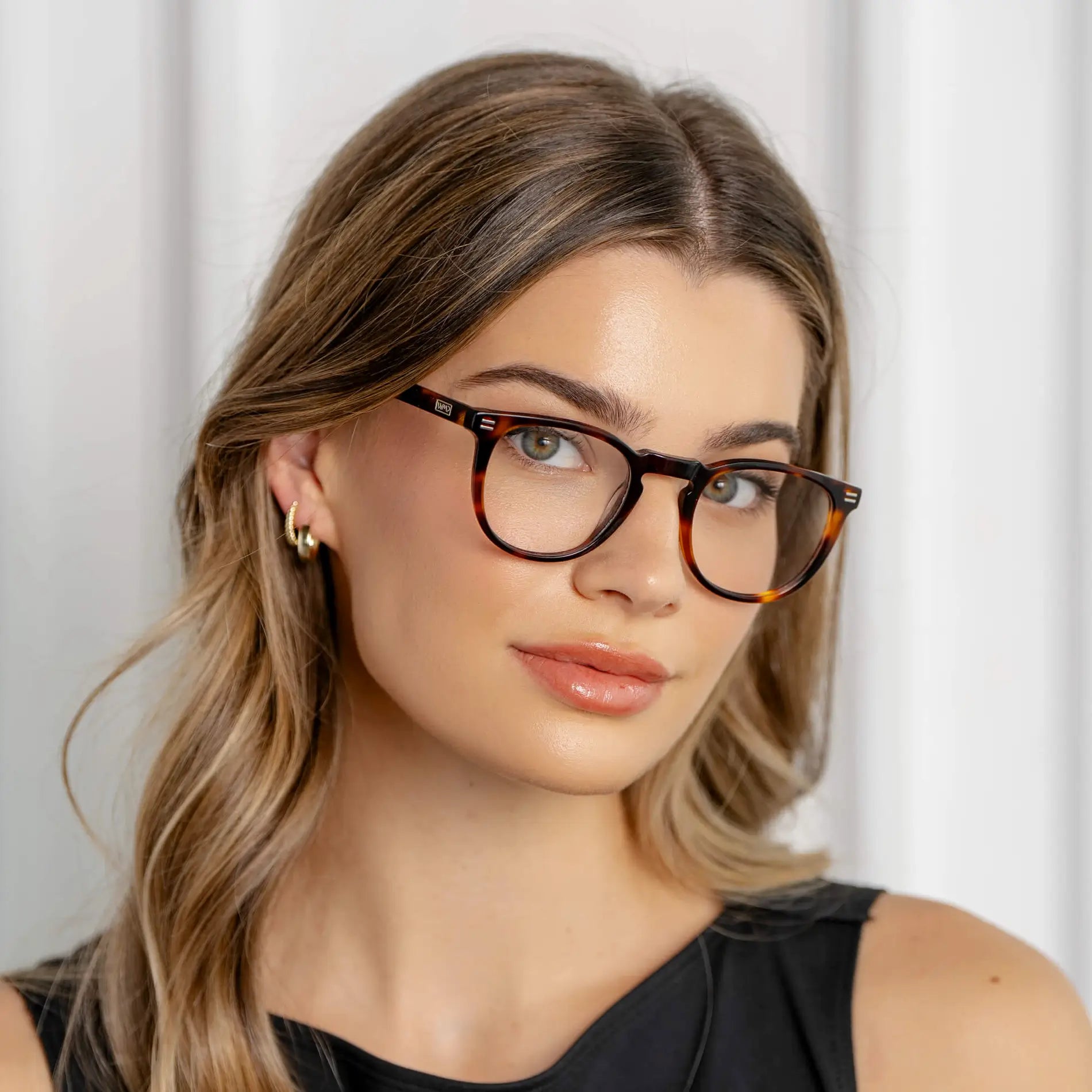 Brown Tortoise || Women's round tortoise shell frame glasses with clear lenses worn by woman with light makeup