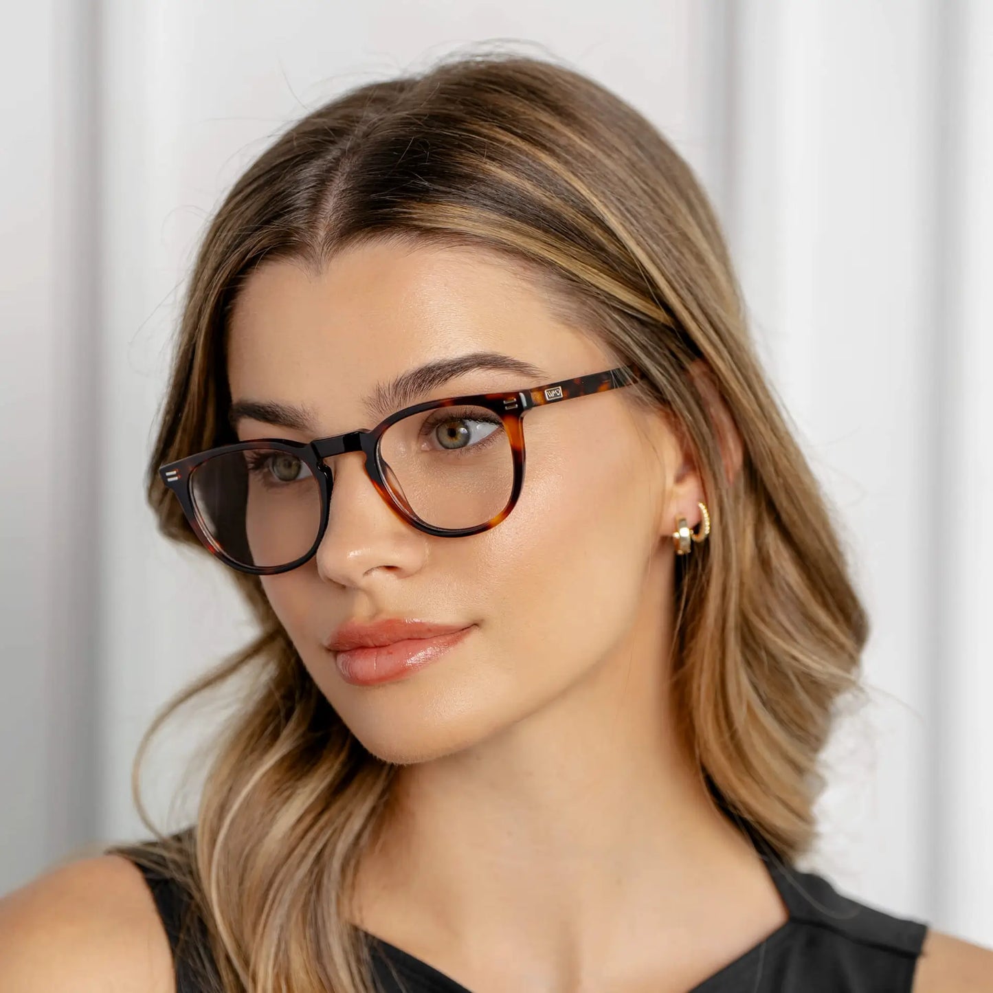 Brown Tortoise || Prescription eyeglasses with round frame and  brown tortoise acetate frame worn by woman looking to the side in natural light