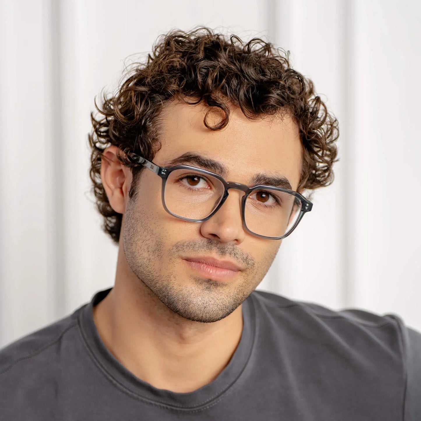 Crystal Stone Blue || Square prescription glasses with crystal stone blue acetate frame and keyhole bridge worn by man indoors