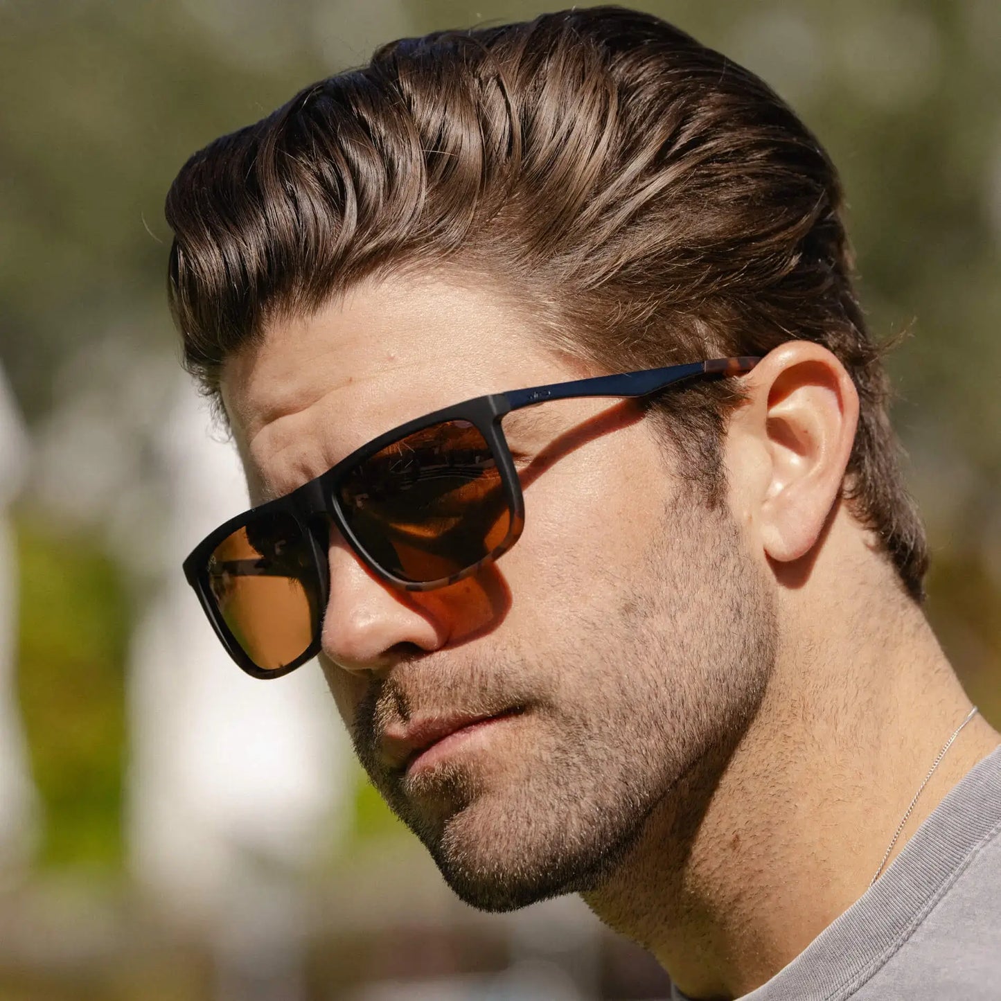 Matte Black Tortoise / Amber || Square prescription sunglasses with black tortoise acetate frame and straight browline featuring amber lenses worn by man outdoors