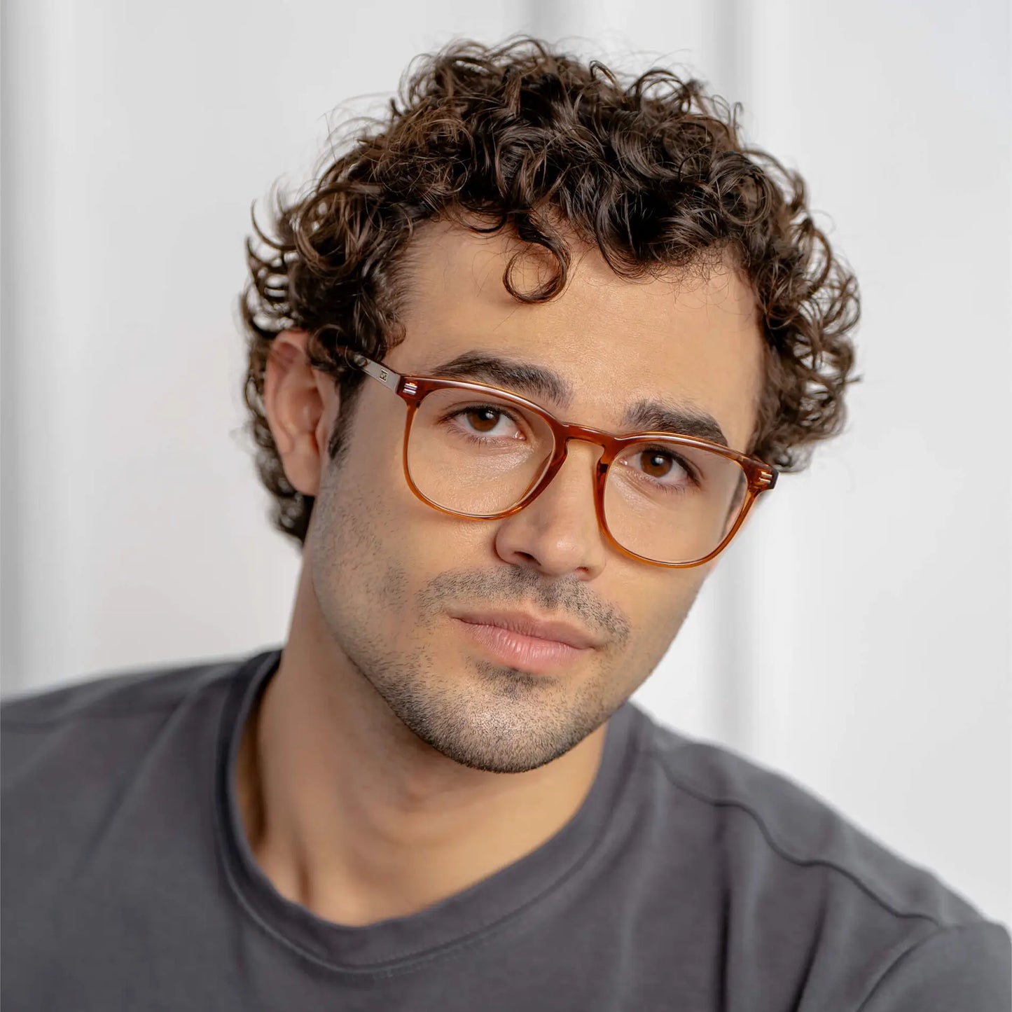 Crystal Brown || Square prescription glasses with crystal brown acetate frame and subtle keyhole bridge worn by man indoors