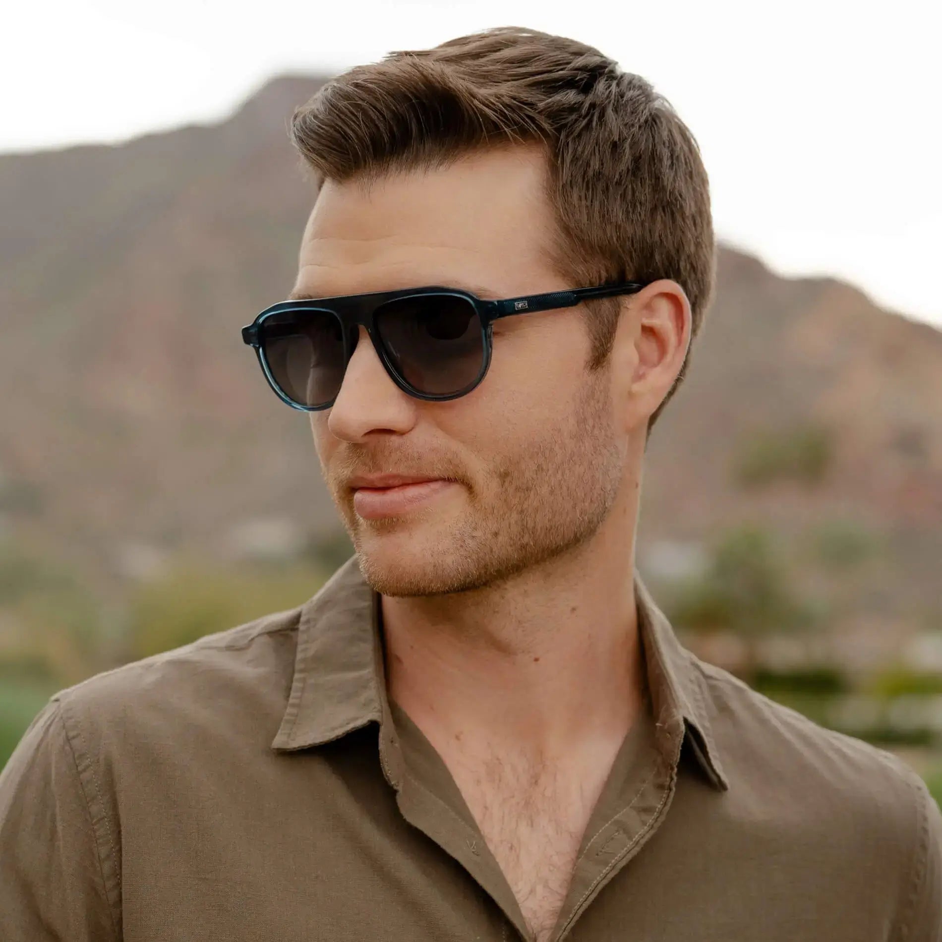 Crystal Cobalt / Grey || Model wearing Men's Aviator Prescription Sunglasses with Blue Frame and Grey Lens