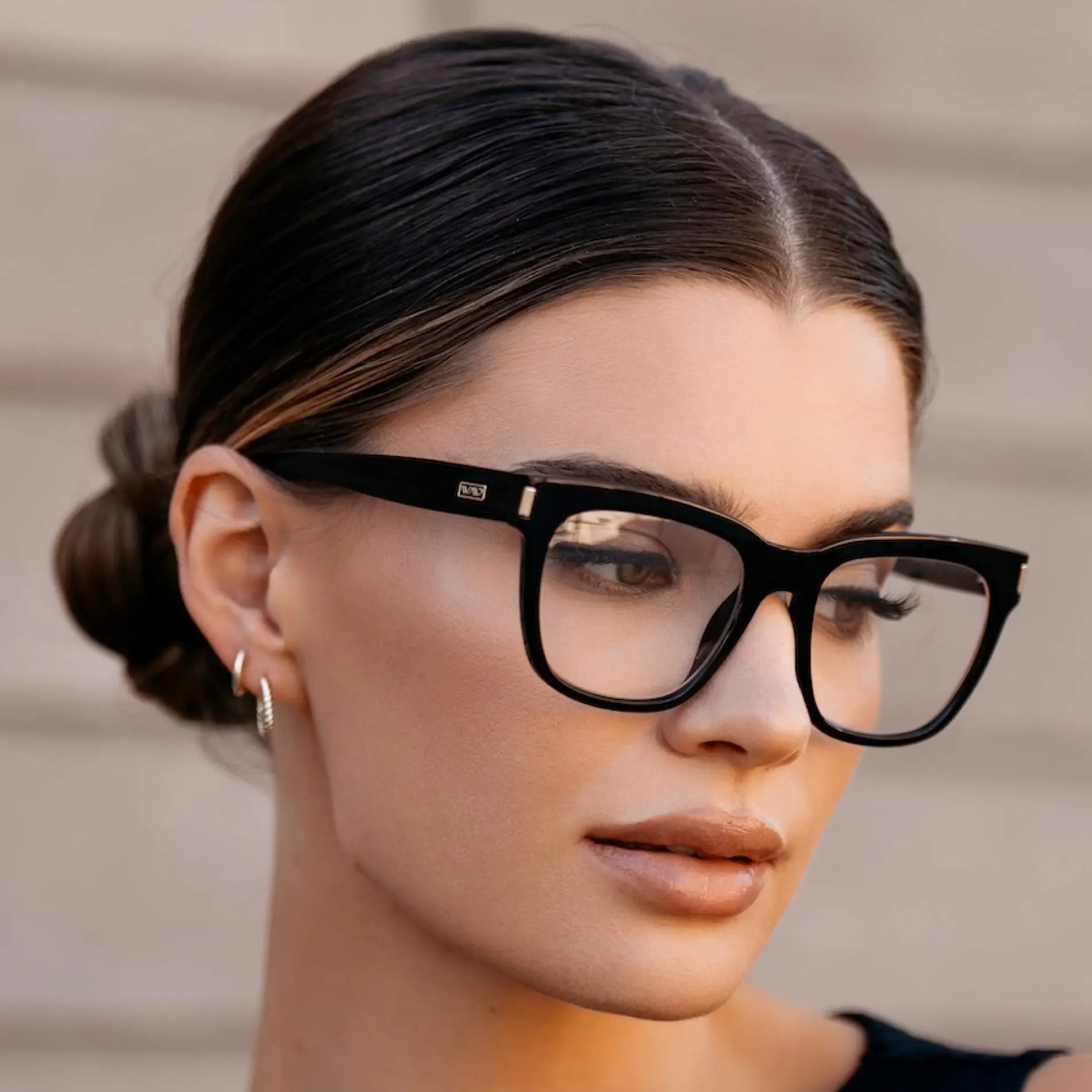 Black || Side profile of thick oversized square prescription eyeglasses with black frame worn by woman outdoors in natural light