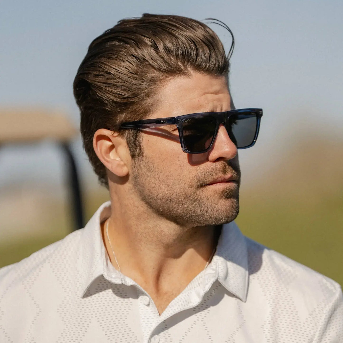 Indigo Blue Grain / Grey || Rectangular prescription sunglasses with blue acetate frame and grey lenses worn by man outdoors