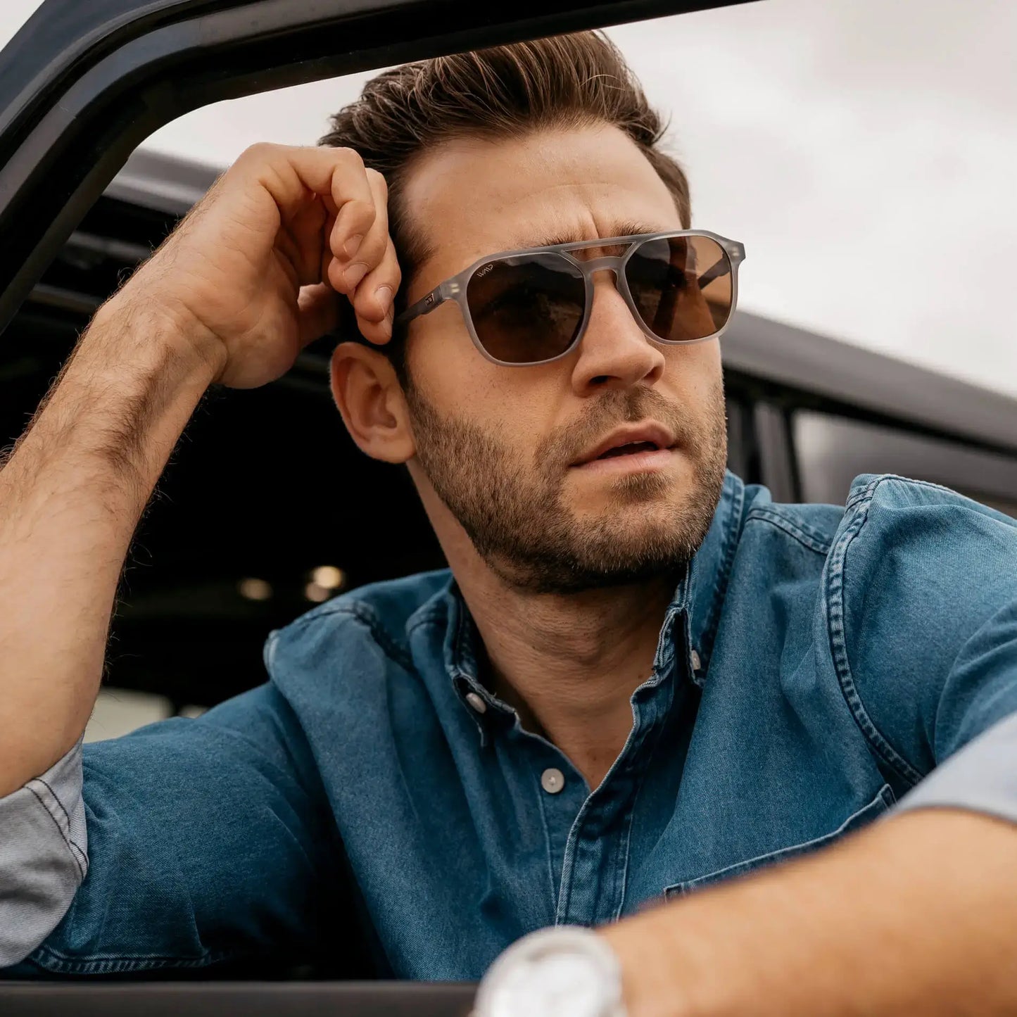 Moonrock Grey / Amber || Square prescription sunglasses with double bridge and grey acetate frame worn by man outdoors