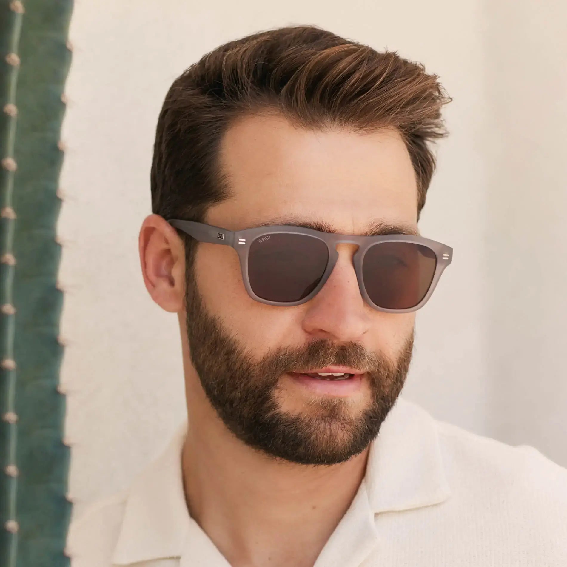 Moonrock Grey / Amber || Square prescription sunglasses with moonrock grey frame, brown lenses and keyhole bridge worn by man outdoors