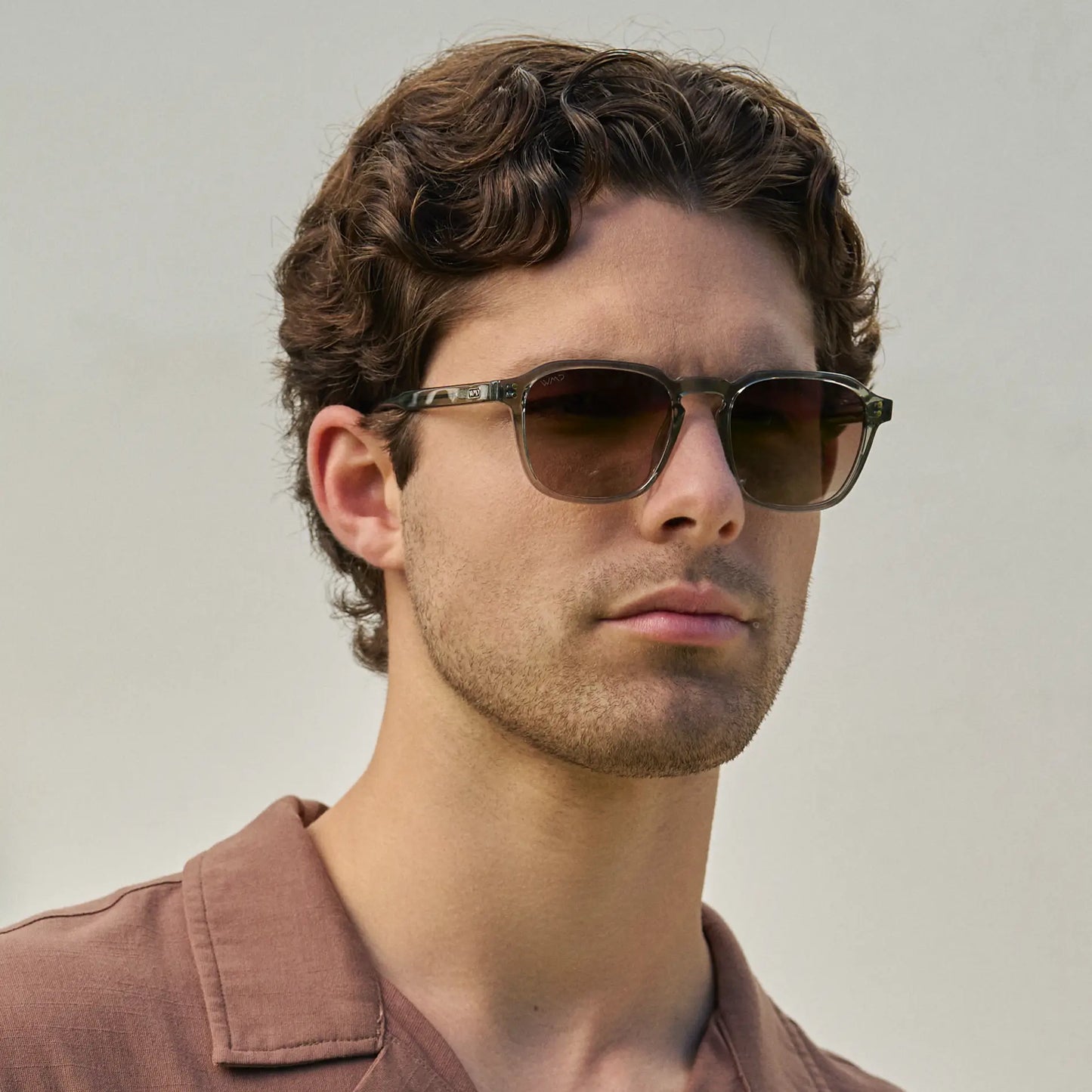 Sage Green / Brown Gradient Lens || Model wearing Men's Sage Green Geometric Square Frame Sunglasses with Brown Gradient Polarized Lenses