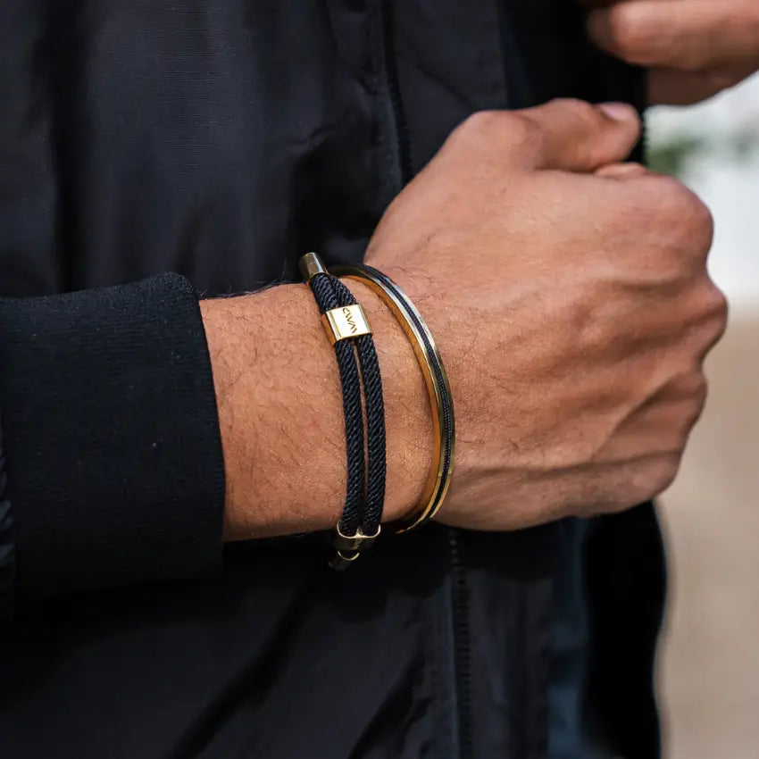 Close-up of a wrist wearing Knox and Kent men's bracelets, featuring poly rope and stainless steel accents.