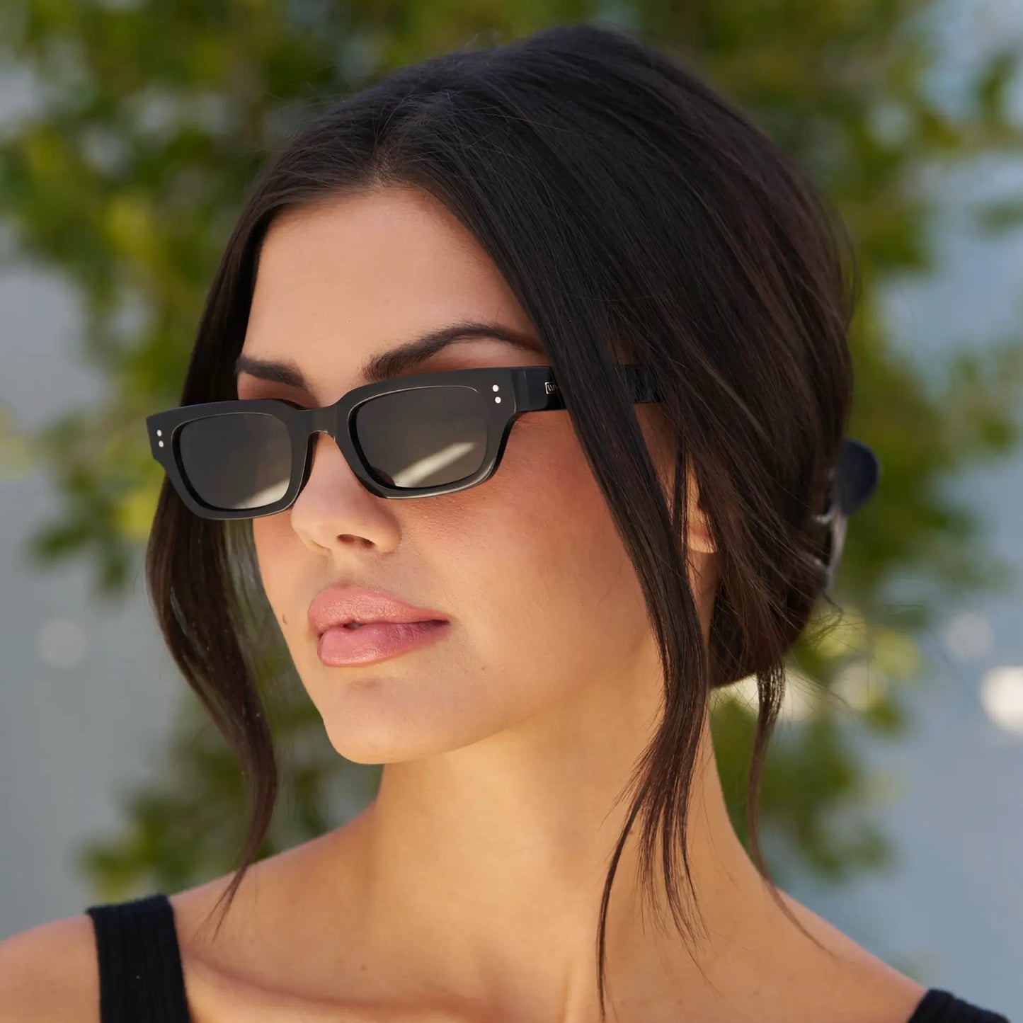 Black / Grey || Women's Rectangular Prescription Sunglasses with Black Frame and Grey Prescription Lens worn by a woman outdoors