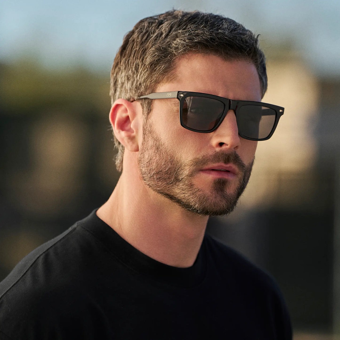 Black / Black Lens || Man wearing Classic Rectangular Sunglasses with Black Frame and Black Lens outdoors
