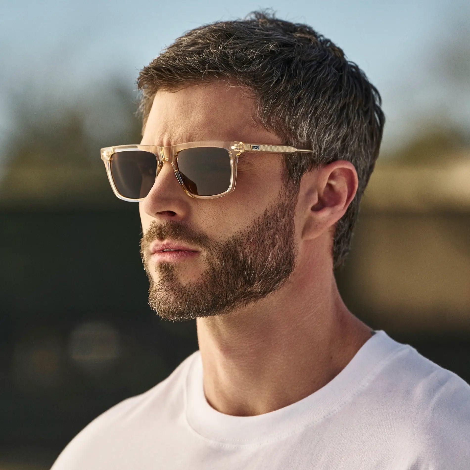Sand Brown / Brown Lens || Man wearing Classic Rectangular Sunglasses with Sand Brown Frame and Brown Lens outdoors