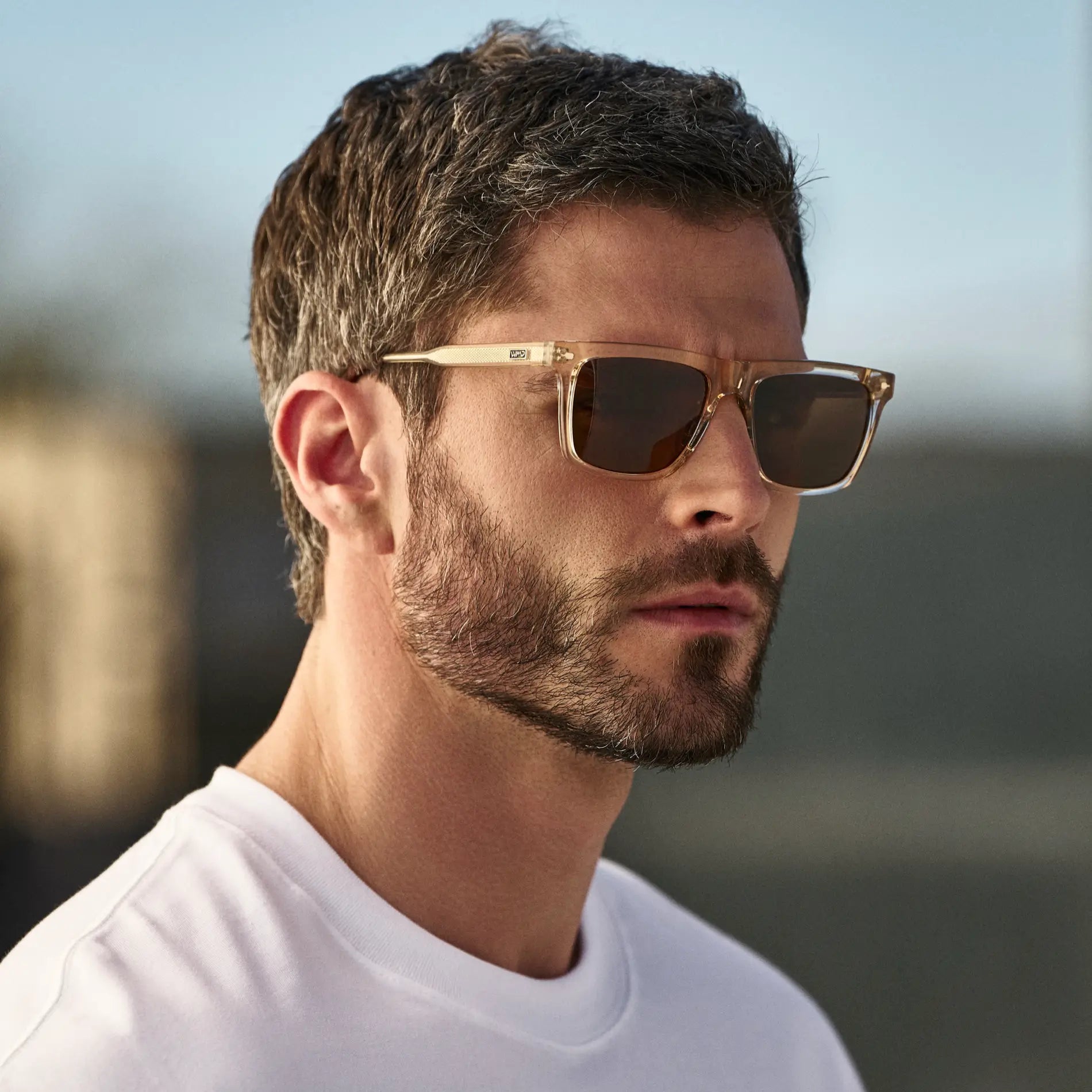 Sand Brown / Brown Lens || Man wearing Classic Rectangular Sunglasses with Sand Brown Frame and Brown Lens outdoors