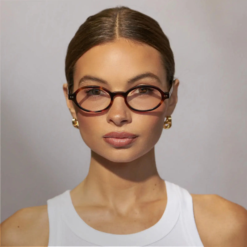 Front-facing close-up of a model wearing Noa prescription eyeglasses in Brown Tortoise.