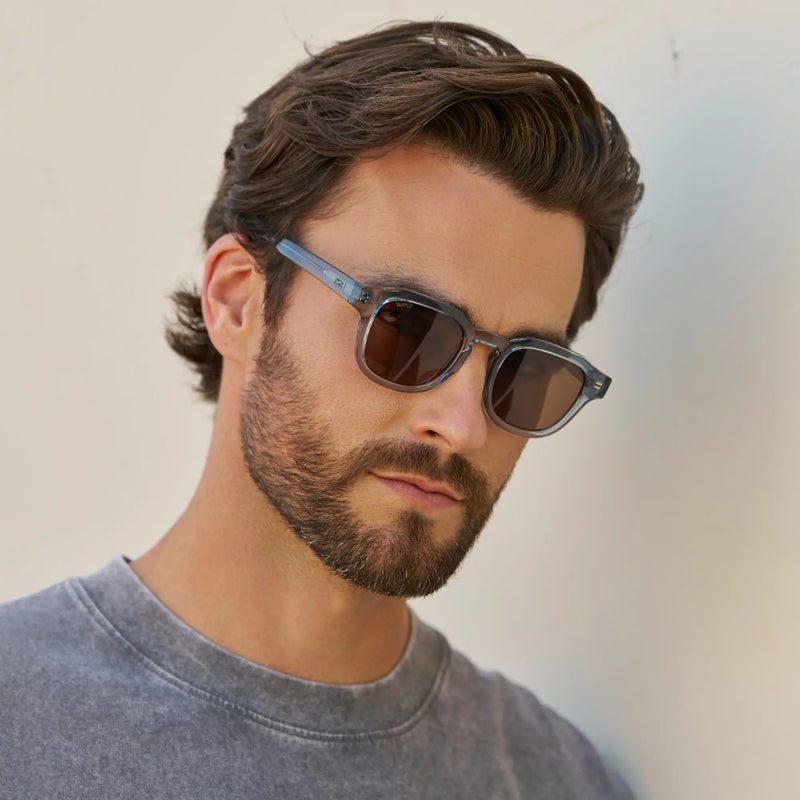 Man wearing WMP Eyewear Nelson sunglasses in denim blue with brown lenses