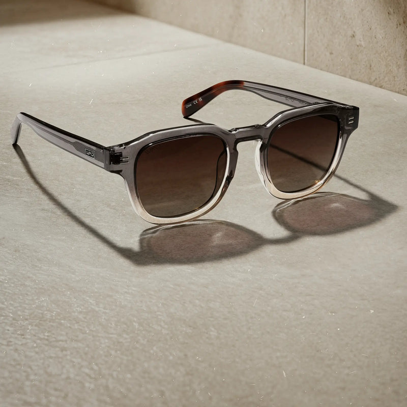 WMP Eyewear Nelson sunglasses in Graphite Horizon Grey, featuring a translucent gray gradient frame with brown gradient lenses.