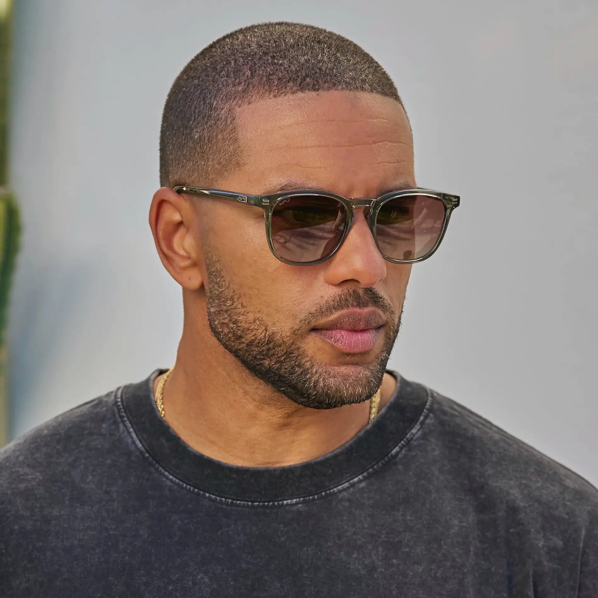 Sage Green / Amber Lens || Model wearing Green Square Frame Prescription Sunglasses with Brown Lenses