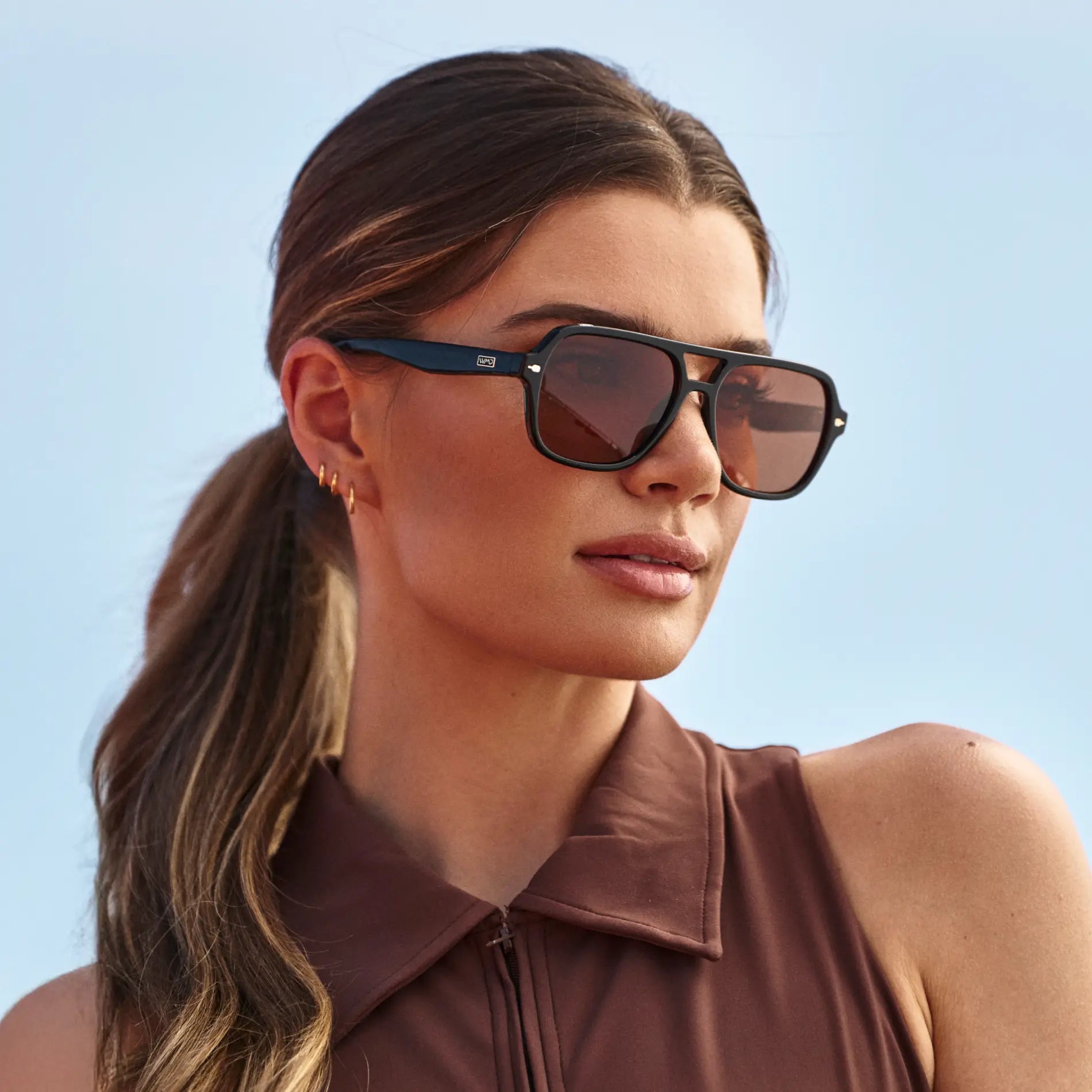 Black / Tinted Red Lens || Woman wearing Flat-Top Aviator Sunglasses with Black Frame and Tinted Red Lens outdoors