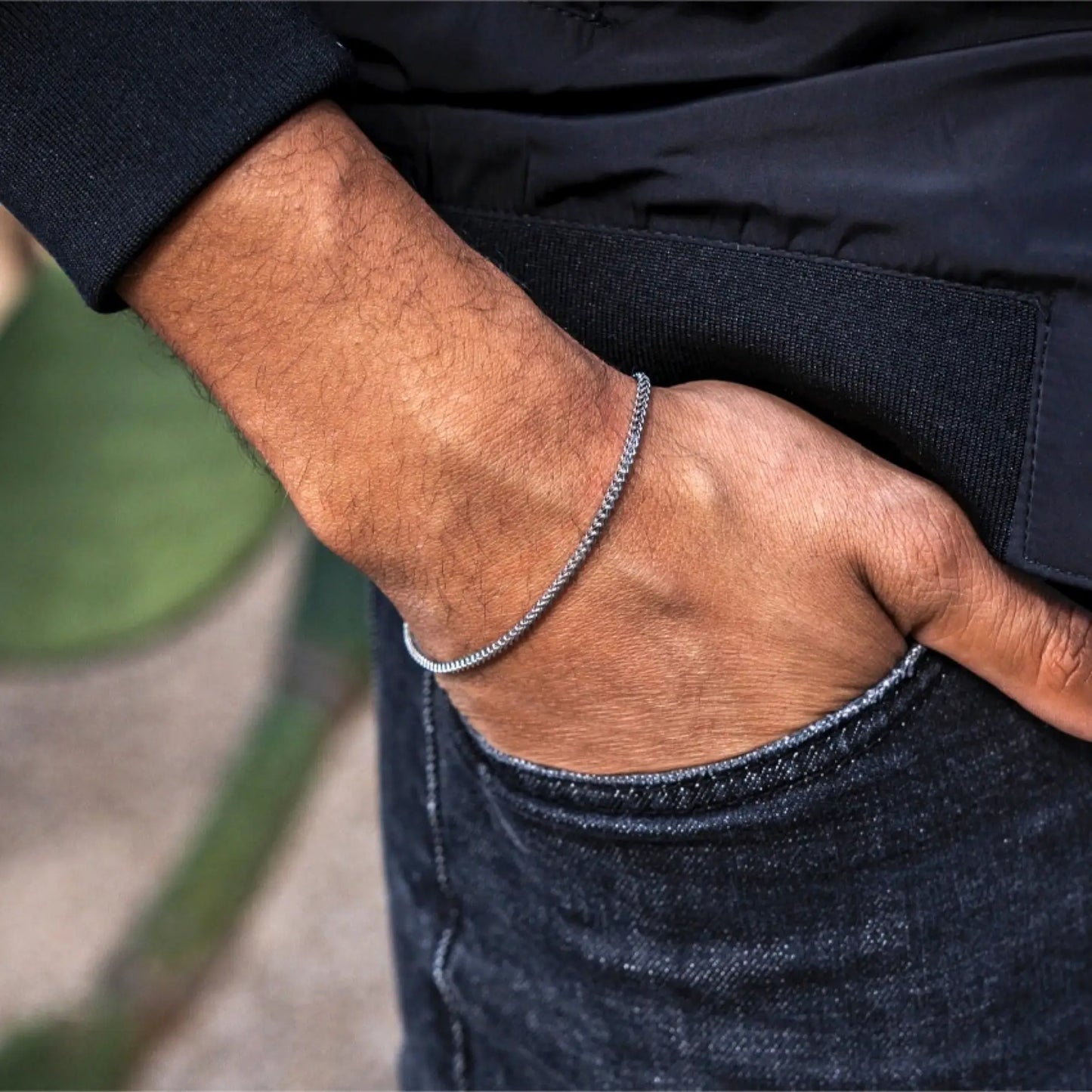 Silver || Minimalist silver chain bracelet worn on wrist with casual dark denim and jacket background in natural light