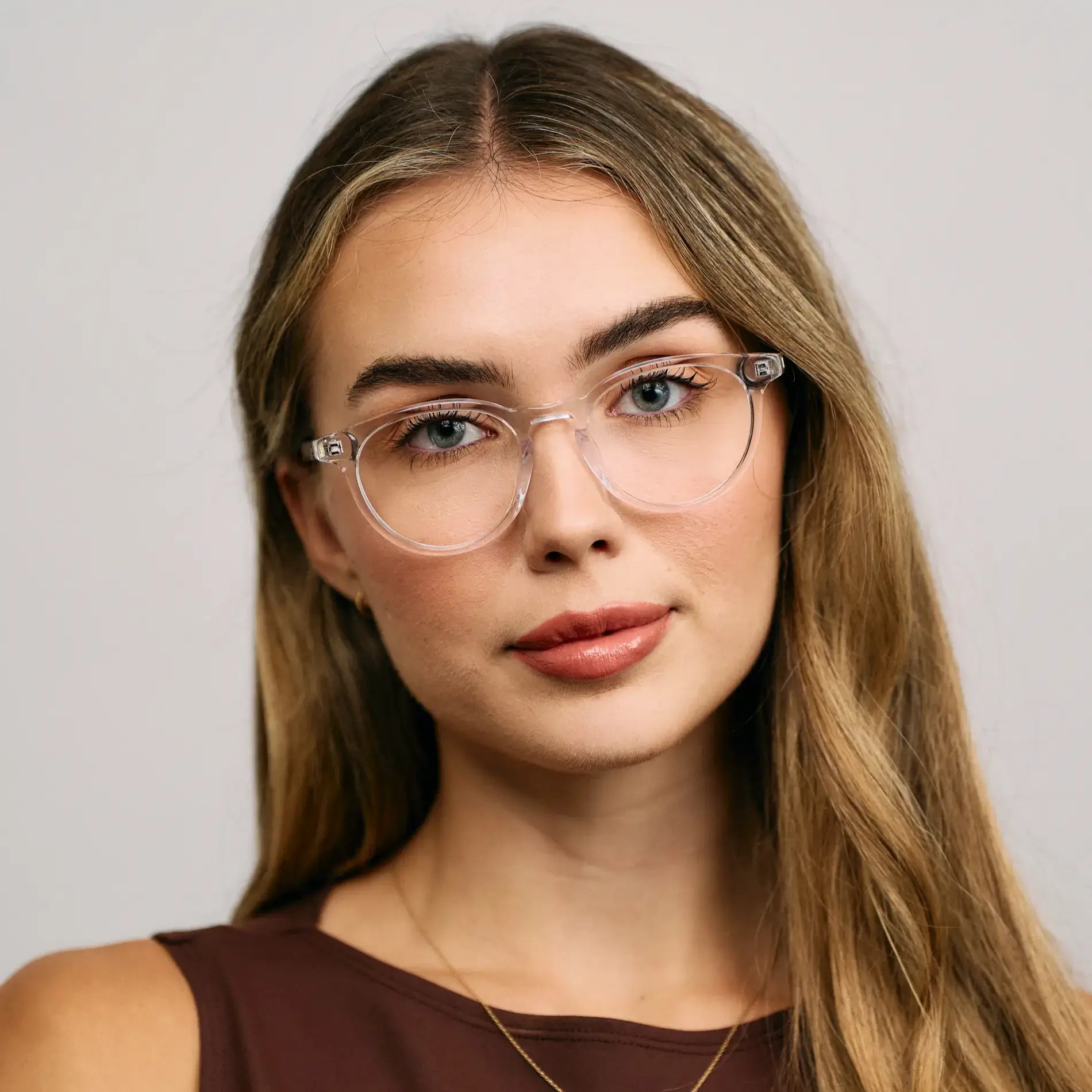Clear || Model wearing Women's Round Prescription Glasses with a Clear Acetate Frame and Clear Lens