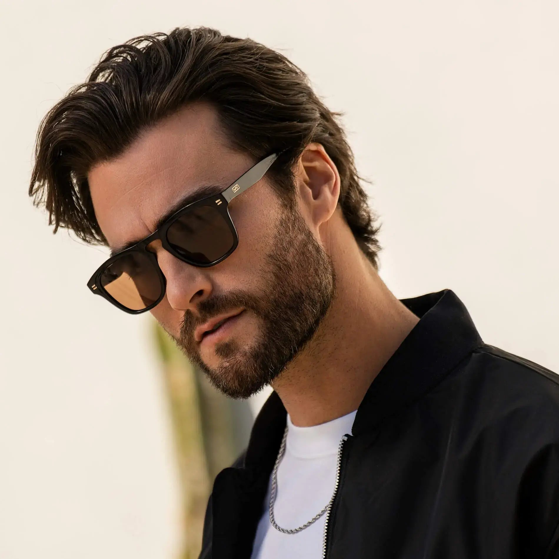 Black / Amber || Square prescription sunglasses with black acetate frame, keyhole bridge, and amber lenses worn by man outdoors