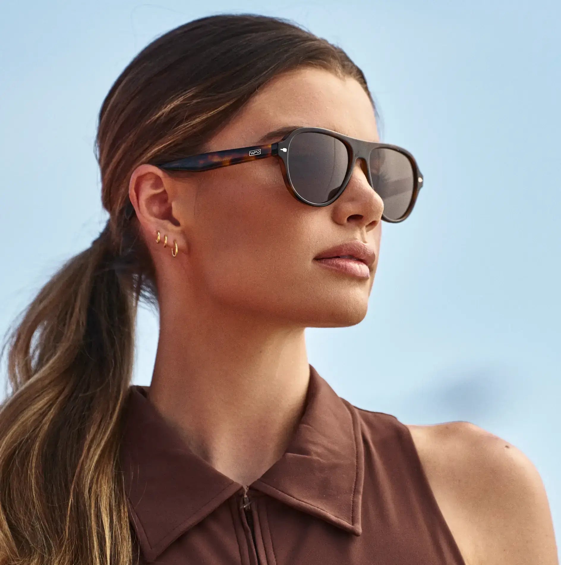 Brown Tortoise / Amber || Woman wearing Rounded Aviator Prescription Sunglasses with Brown Tortoise Frame and Brown Lenses outdoors
