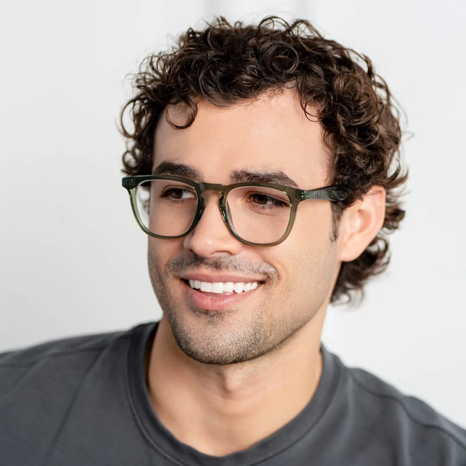 Crystal Agave Green || Round prescription glasses with crystal green acetate frame and subtle keyhole bridge worn by man indoors