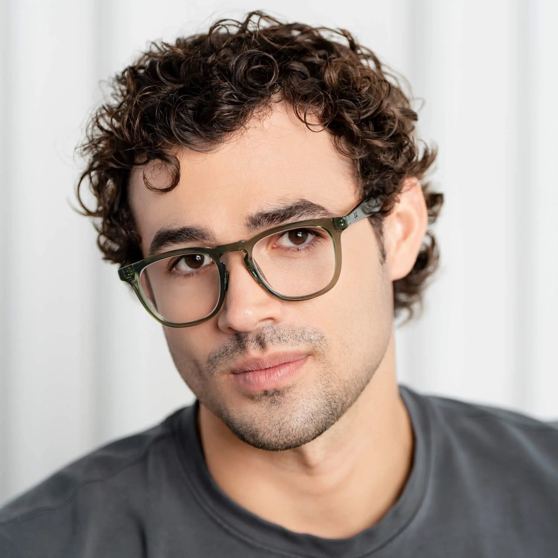 Crystal Agave Green || Round prescription glasses with crystal green acetate frame and flat keyhole bridge worn by man indoors