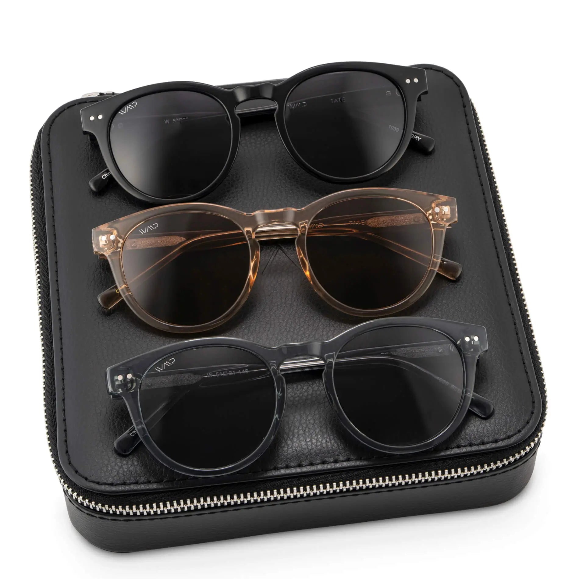 Black Case || Three pairs of round frame sunglasses in black, translucent brown, and translucent gray, displayed on a black zippered case