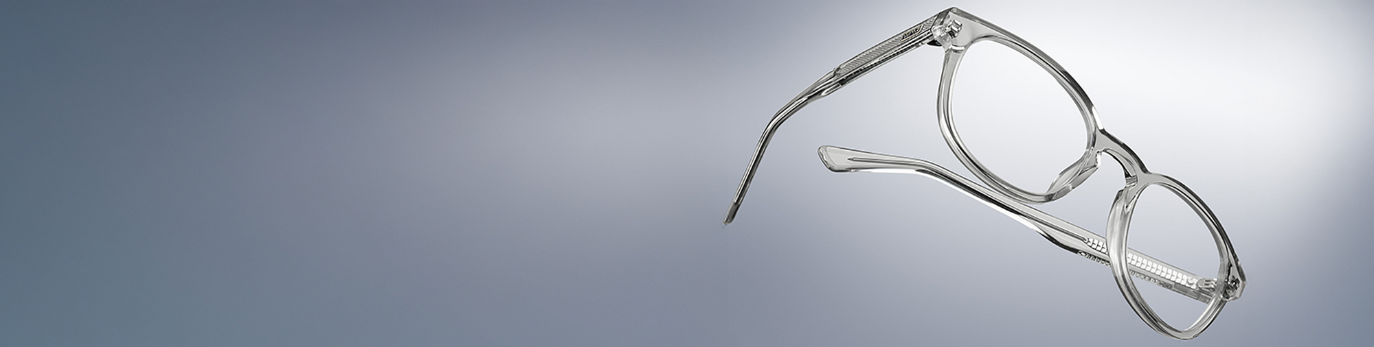 Clear eyeglasses on a gradient gray background