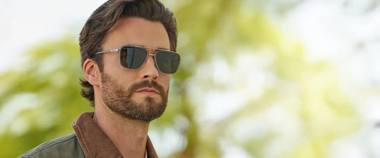 Model wearing WMP Eyewear Weston sunglasses in Smoke Grey, featuring a sleek rectangular frame with slim silver metal temples and smoke green lenses.